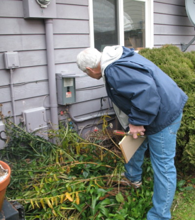 Dan inspecting a home's electrical meter.