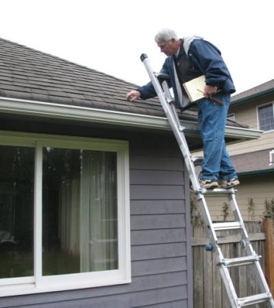 Dan inspecting a home's roof.